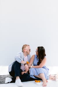 David and Meivys sitting together in a bright studio